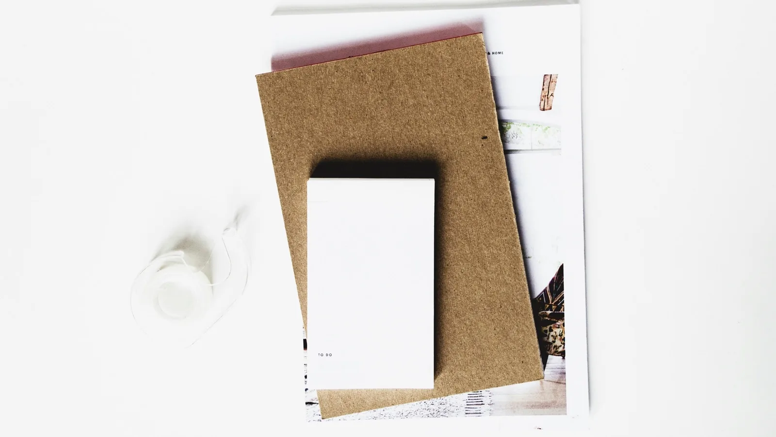 An organized stack of folders, paper, and stationery